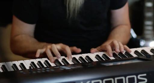 close up of Jordan playing keyboard.