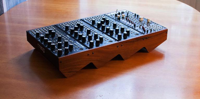 a bunch of Moog Mother 32s in a sawtooth wood panel stand / case.