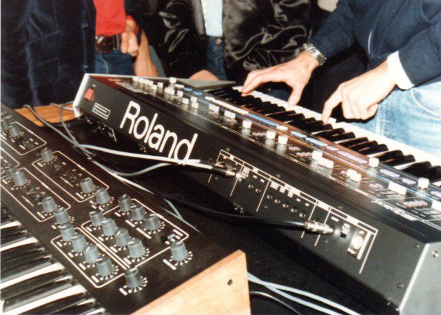 Photo from the first public demonstration of MIDI at the 1983 NAMM show. Seen here are a Roland Jupiter 6 and a Sequential Circuits Prophet 600 connected via MIDI cables. Photo courtesy of Dave Smith.