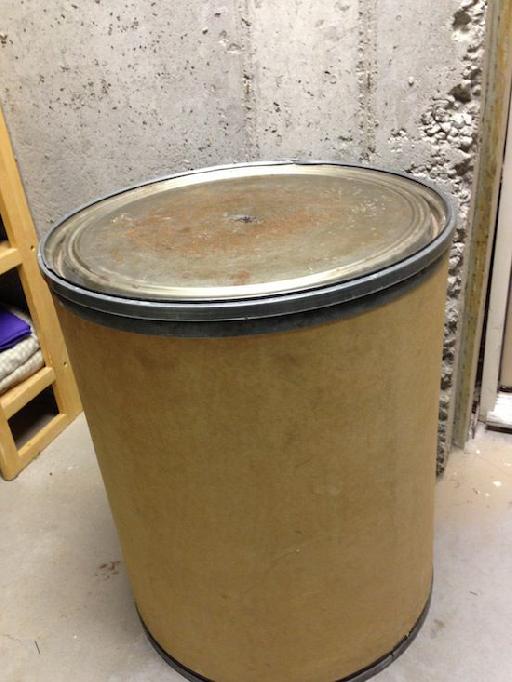 Cardboard barrel with metal canister lid. $10 at a second hand store.