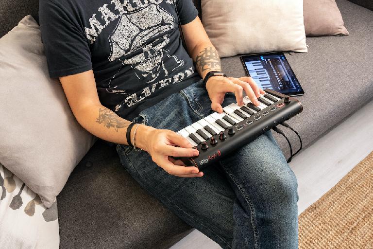 On the sofa with iRig Keys 2 Mini MIDI Controller.